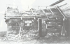 A pioneer German homesteader in the Saskatchewan bush improving his first dwelling, 1934.