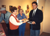 Betty Brosz and Alice Hollan present Peter Hilkes with German kuchen and a cassette tape from the James Valley Chapter during his visit to Jamestown, ND, October 1993.