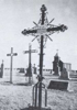 Iron cross with triple circles containing eight-pointed stars in Victoria, Kansas cemetery.