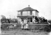 George J. Wentz house and fenced yard in Streeter, North Dakota. Standing in front of the house are mother Margaretha Graf Wentz (Christina Graf Buck's sister) and her three daughters. Circa 1912.